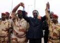 AFP | Chad's President Idriss Deby Itno (C) holds hands with Chadian army chiefs and his son Mahamat Idriss Deby (R) in N'Djamena in 2013