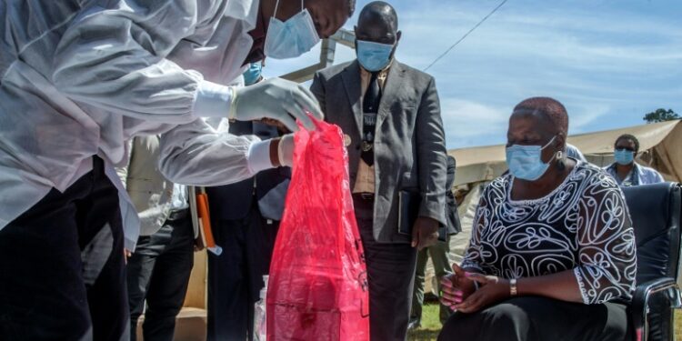 A batch of AstraZeneca from the AU had just a two-week shelf life, Health Minister Kumbize Kandodo, right, noted as the doses were incinerated | AFP