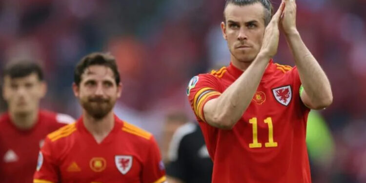 Gareth Bale (right) has pledged to continue leading Wales as captain | AFP
