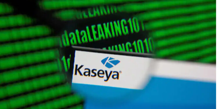 Kaseya’s webpage is seen through a magnifying glass in front of displayed binary code in this illustration on July 6 | Dado Ruvic/Reuters