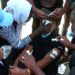 Sudanese protesters treat a young man's wounds at the scene of confrontations with security forces, in the capital Khartoum on December 25, 2021, during a demonstration demanding civilian rule | AFP