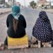 Sudanese women sit atop a brick barricade at 60th Street on January 18, 2022 in the capital Khartoum as part of a civil disobedience campaign following the killing of seven anti-coup demonstrators | AFP