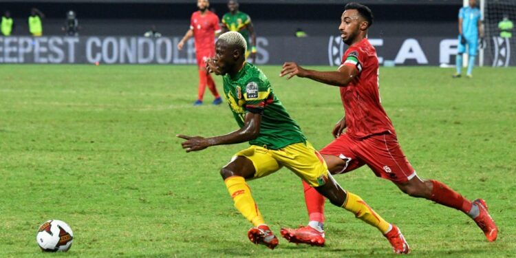 Mali winger Moussa Djenepo (L) is pursued by Equatorial Guinea captain and defender Carlos Akapo during an Africa Cup of Nations last-16 match in Limbe on Wednesday | AFP