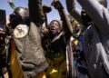 Several hundred people gathered in Burkina Faso's capital Ouagadougou on Tuesday to applaud the military takeover | AFP