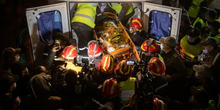 Moroccan emergency services teams carry the body of five-year-old Rayan into an ambulance after pulling him from a well shaft | AFP