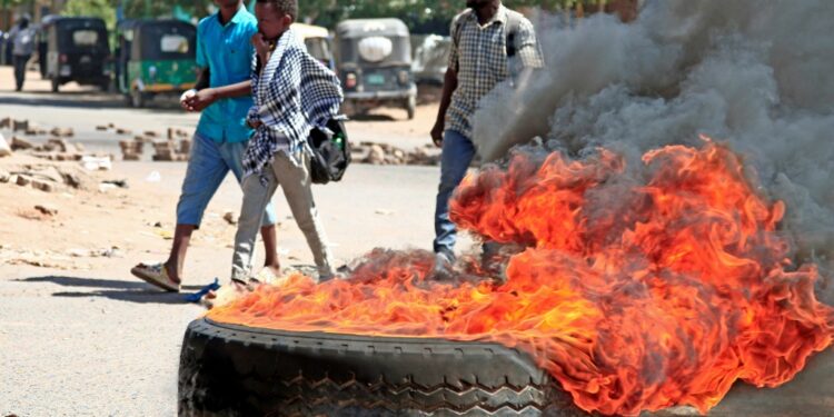Sudanese anti-coup protesters burn tyres during a demonstration in Khartoum against the military's takeover | AFP