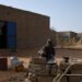 A Malian refugee cooks outside her home in Ouallam | AFP