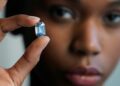 Model Stephany Martins holds up the "The De Beers Cullinan Blue" blue diamond during a press preview at Sotheby's in New York, on February 15, 2022 | AFP