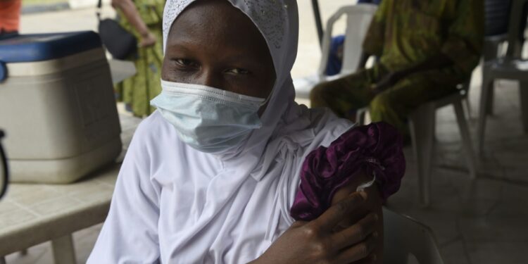 A woman gets her Covid-19 jab at the Secretariat Community Central Mosque, Alausa, Ikeja in Lagos | AFP