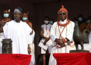 The King, known as Oba of Benin (right) received the artefacts | AFP