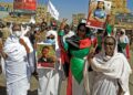 Demonstrators in Khartoum North hold pictures of protesters killed in earlier demonstrations, during a march calling for civilian rule | AFP