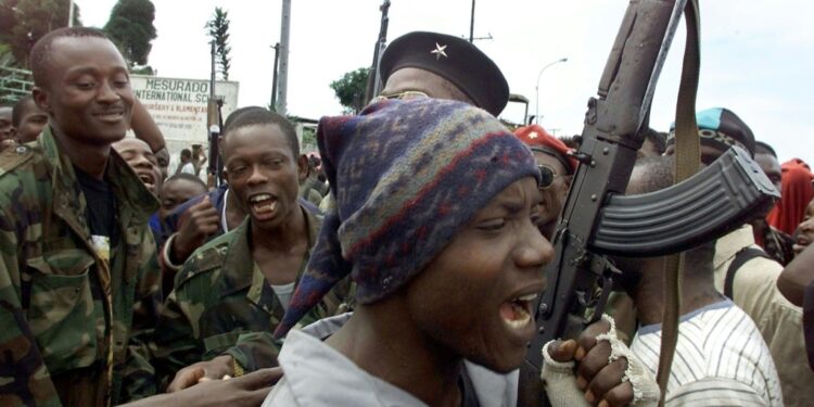LURD rebels are seen in August 2003 near a Monrovia suburb | AFP