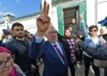 Tunisia's speaker of the dissolved parliament, Rached Ghannouchi, flashes the victory sign as he arrives for questioning at the judicial police headquarters in the capital Tunis | AFP