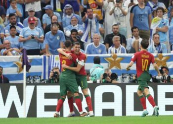 Portugal players celebrate after scoring a goal against Uruguay at the World Cup: IMAGE/Getty Images