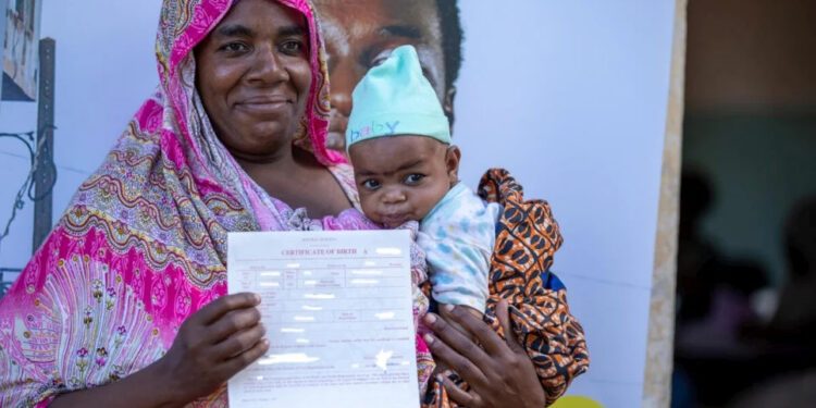 Laila Rashidi, a 48-year-old mother of 10 from the Pemba community in Kenya collects a birth certificate for her son. PHOTO/UNHCR