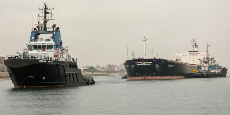 A tugboat pulls the Marshall Islands-flagged bulk carrier M/V Glory in the Suez Canal after it was refloated: IMAGE/AFP