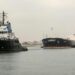 A tugboat pulls the Marshall Islands-flagged bulk carrier M/V Glory in the Suez Canal after it was refloated: IMAGE/AFP