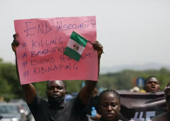 Parents and relatives of students from the Federal College of Forestry Mechanization in Kaduna, who were kidnapped, hold placards during a demonstration in Abuja on May 4, 2021. | Kola Sulaimon/AFP via Getty Images